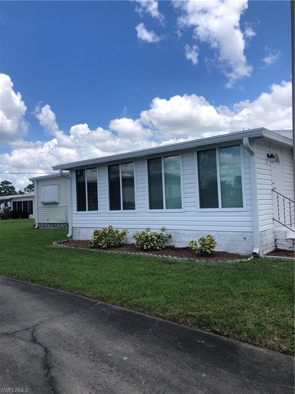 View of front of house with a front yard