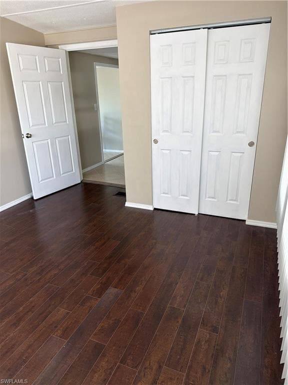 Rich wood-finish flooring complements the neutral wall color