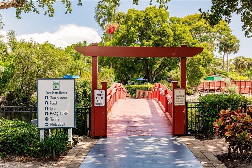Community amenities include a restaurant, pool, spa, BBQ grills, tennis, and pickleball, accessed via a red wooden bridge