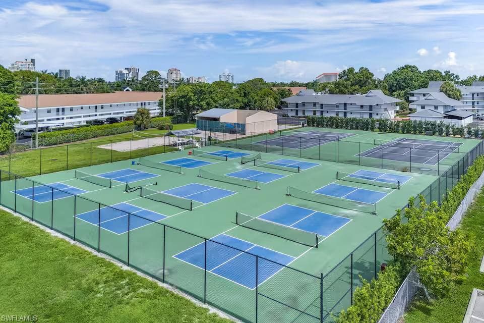 This property features multiple pickleball courts and tennis courts, providing ample opportunities for recreation
