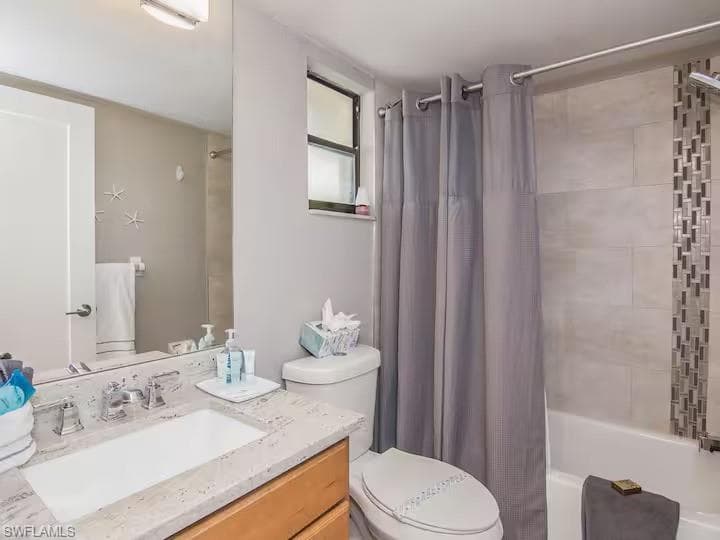The bathroom features a vanity with a rectangular sink and a light-colored countertop