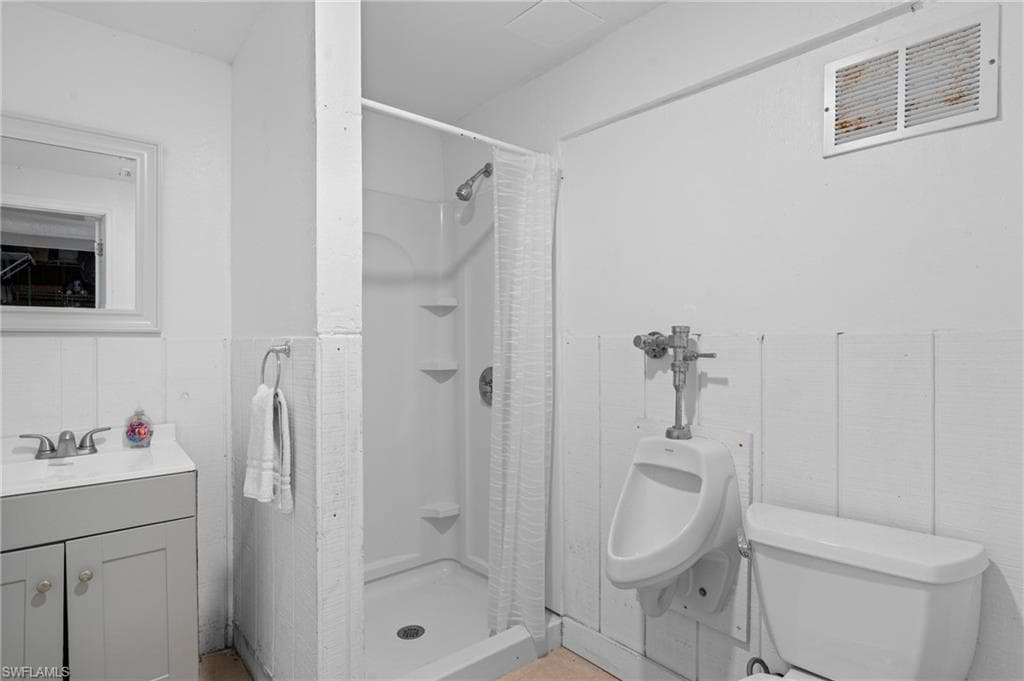 Bathroom with a walk-in shower and vanity - - Virtually Edited Image
