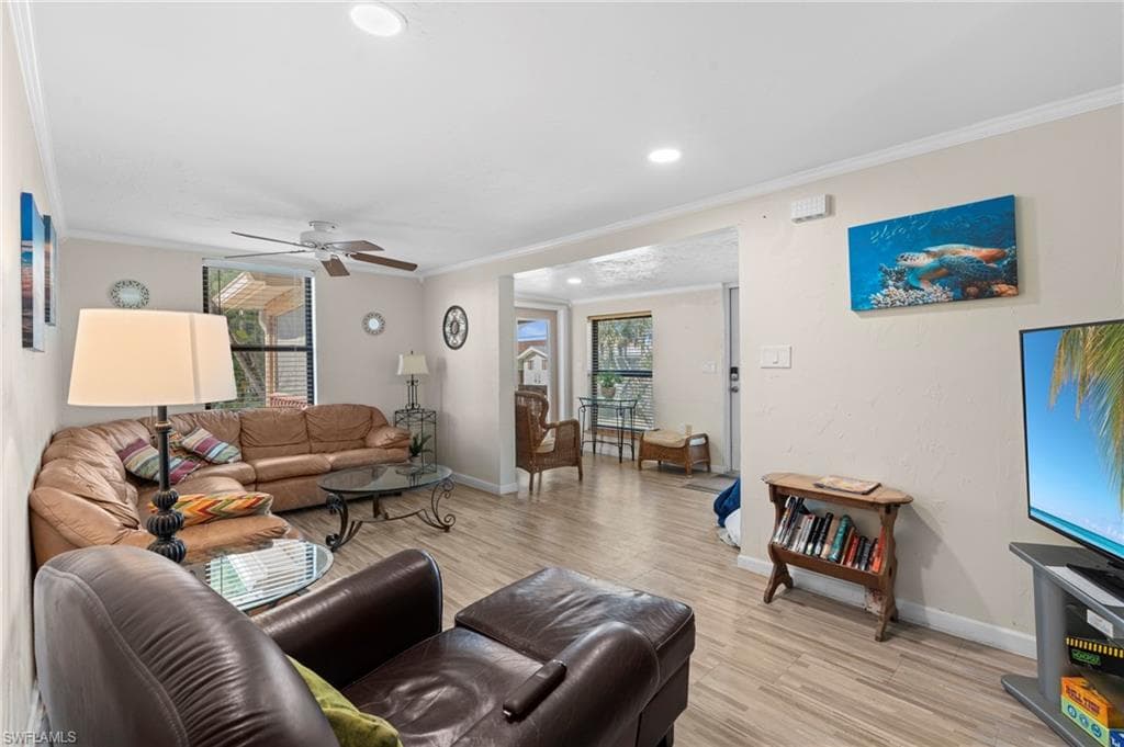 Living room featuring comfortable seating and an open layout that flows seamlessly into the dining area - Virtually Edited Image