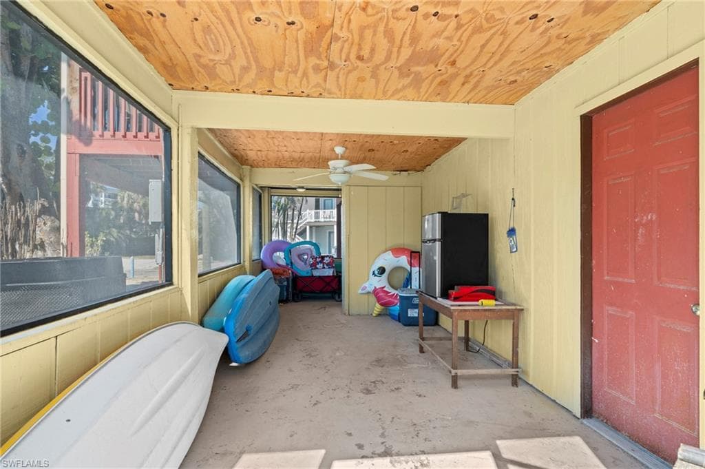 Screened-in storage or utility area, ideal for stashing beach gear, kayaks, and outdoor essentials - Virtually Edited Image
