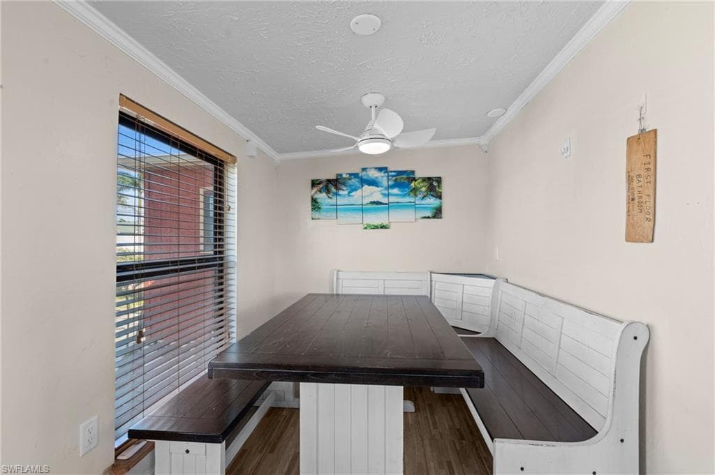 Dining area features a built-in corner bench with natural light offering a cozy and inviting spot for meals - Virtually Edited Image