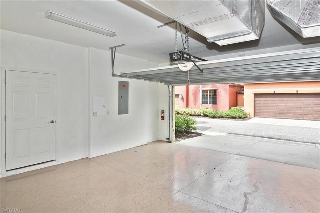 ...the roomy 2-car garage with epoxied flooring. The door on the left opens into...