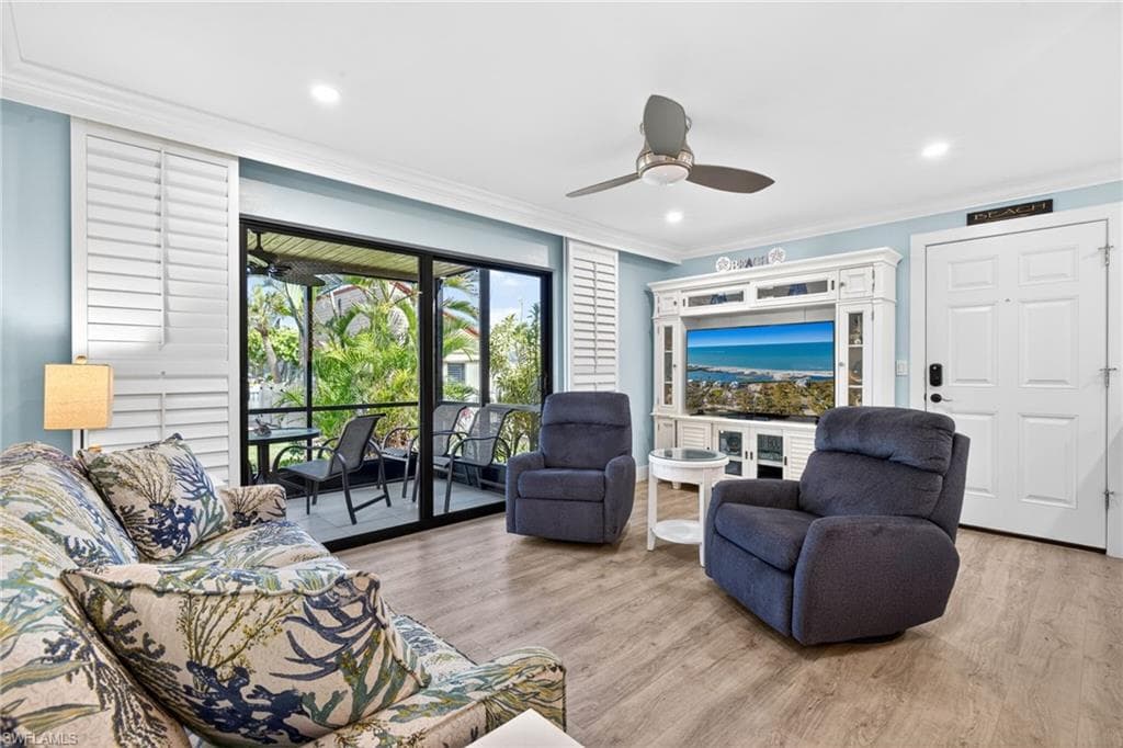 Open-concept living area featuring wood-finish flooring, recessed lighting, and a ceiling fan