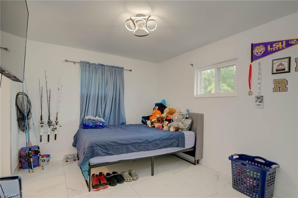 Bright interior room with white walls and large format tile flooring
