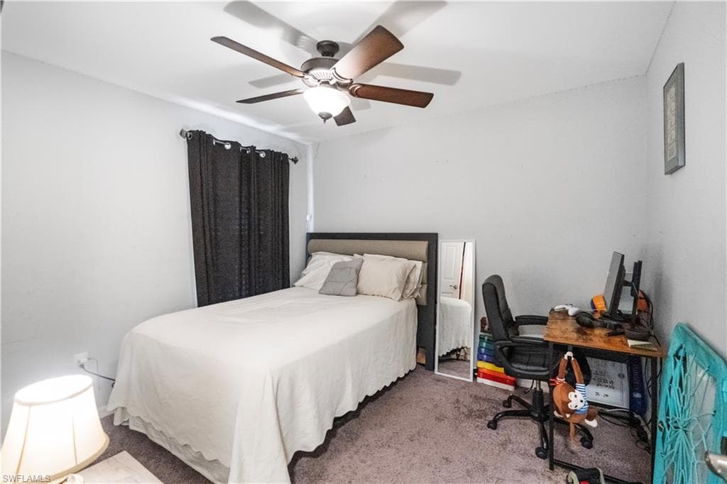 Neutral wall color with dark-toned window treatments and a ceiling fan with integrated lighting