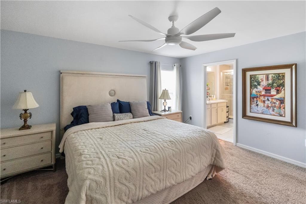 Plush carpeting and light blue wall tones define this bedroom space