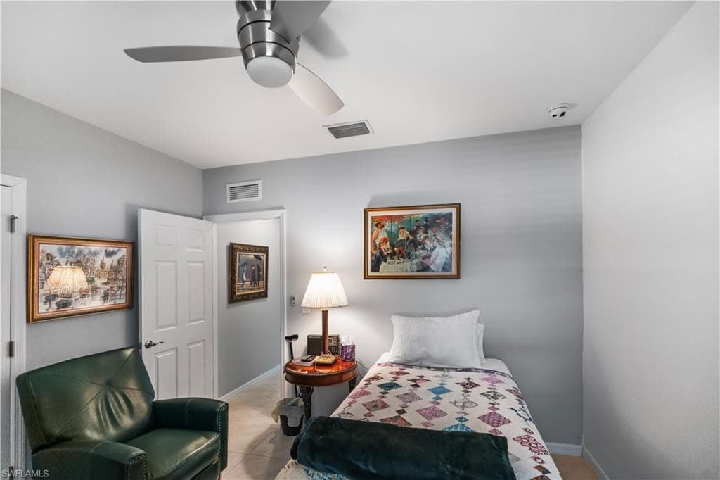 Neutral gray painted walls with a ceiling fan featuring brushed nickel accents