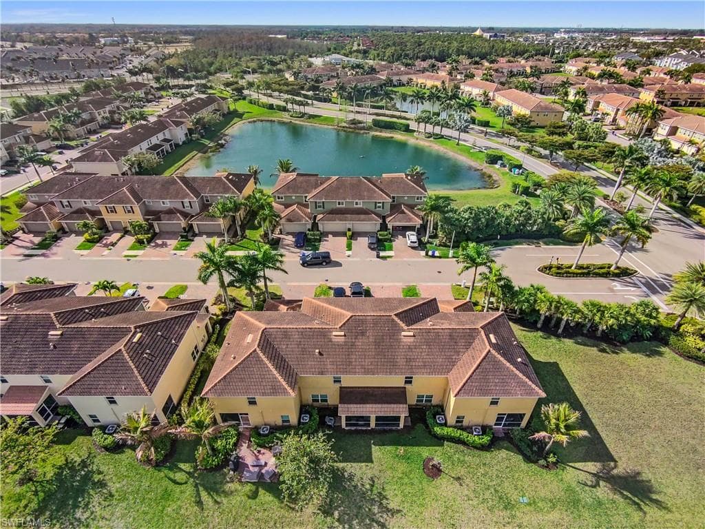 Aerial perspective showcasing a residential community with a central water feature