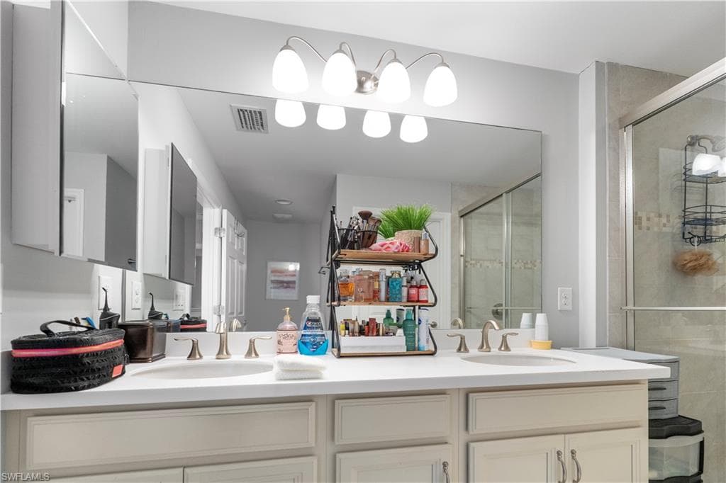 Dual sinks set in a light-toned countertop, accompanied by matching cabinetry