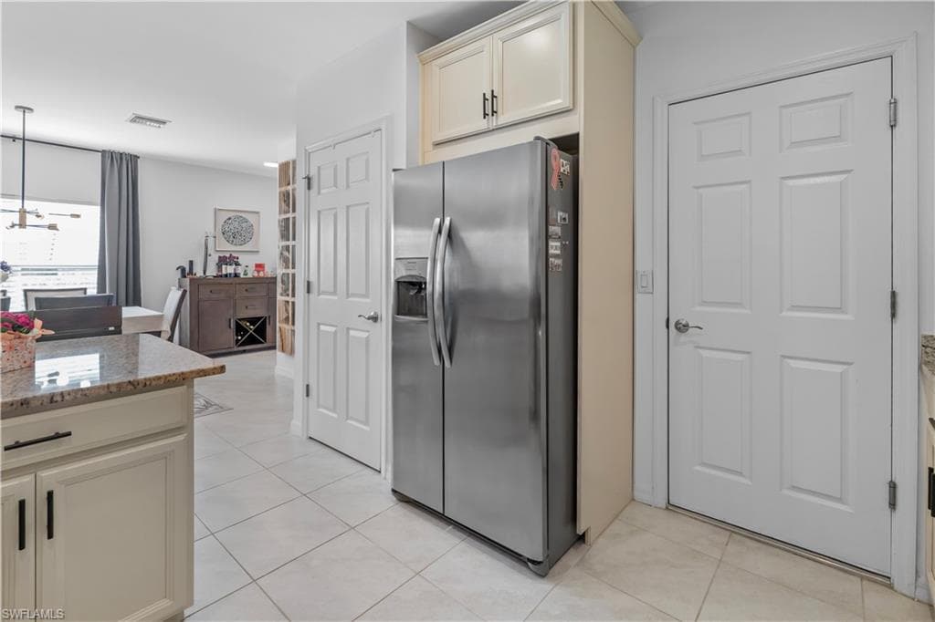Kitchen with light-toned cabinetry and granite countertops