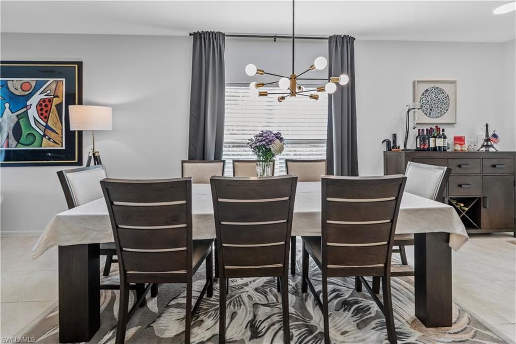 Dining area featuring a modern chandelier with spherical lights, a window with horizontal blinds and drapery, and wood-finish flooring