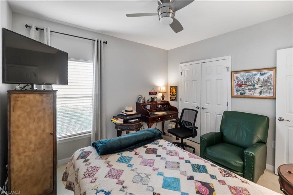Room featuring light gray painted walls, a ceiling fan, and a window with white blinds and dark curtain rods