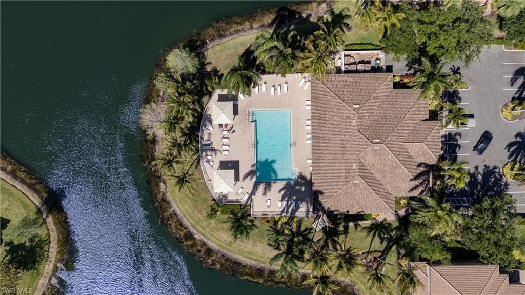 Resort-style pool area with ample lounge seating and shaded cabanas