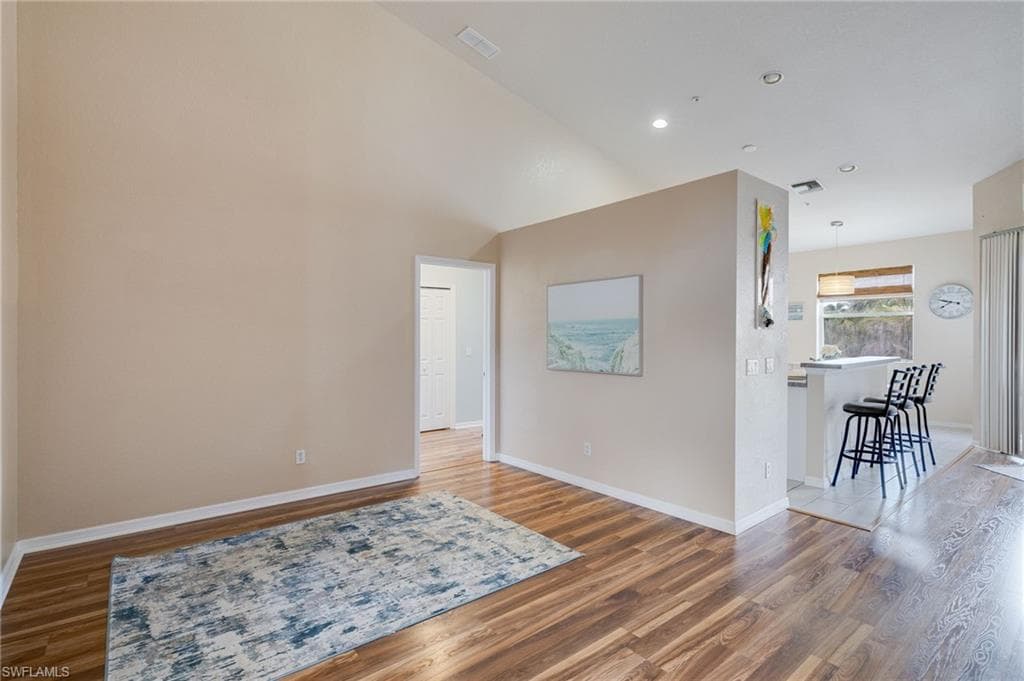 Interior space featuring wood-finish flooring, vaulted ceilings, and recessed lighting
