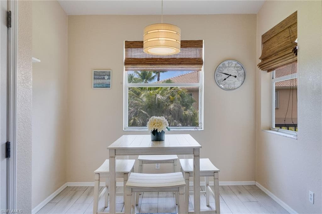 Breakfast nook with wood-finish flooring and neutral wall tones