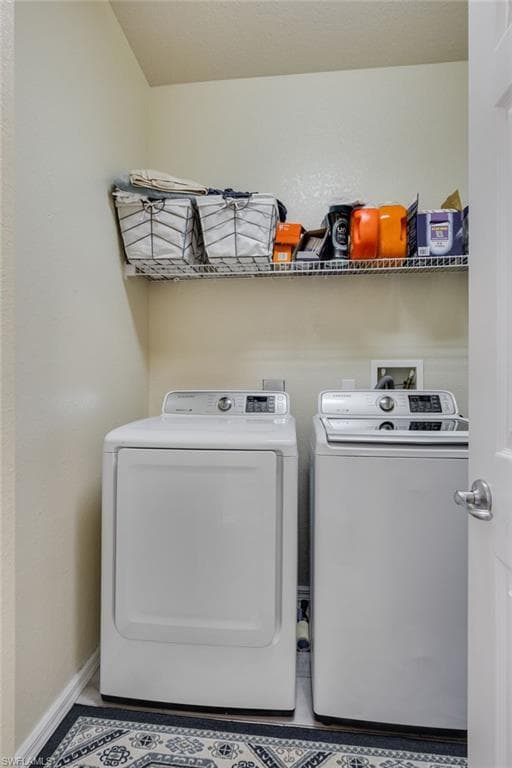 Laundry area featuring a wire shelving unit, light-colored walls, and a patterned floor mat