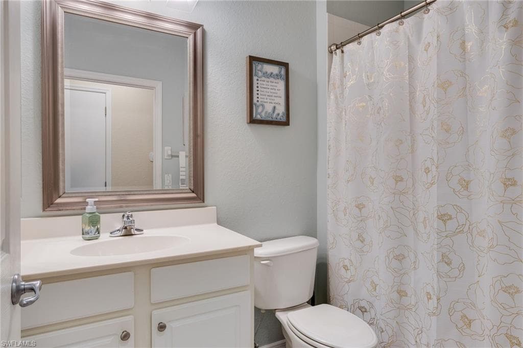 Bathroom vanity with a framed mirror, an integrated sink, a two-door cabinet, and a chrome faucet