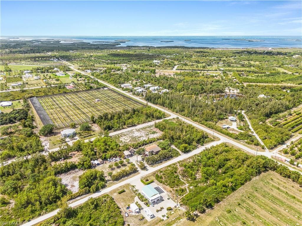 Aerial view of home and adjacent vacant lots.