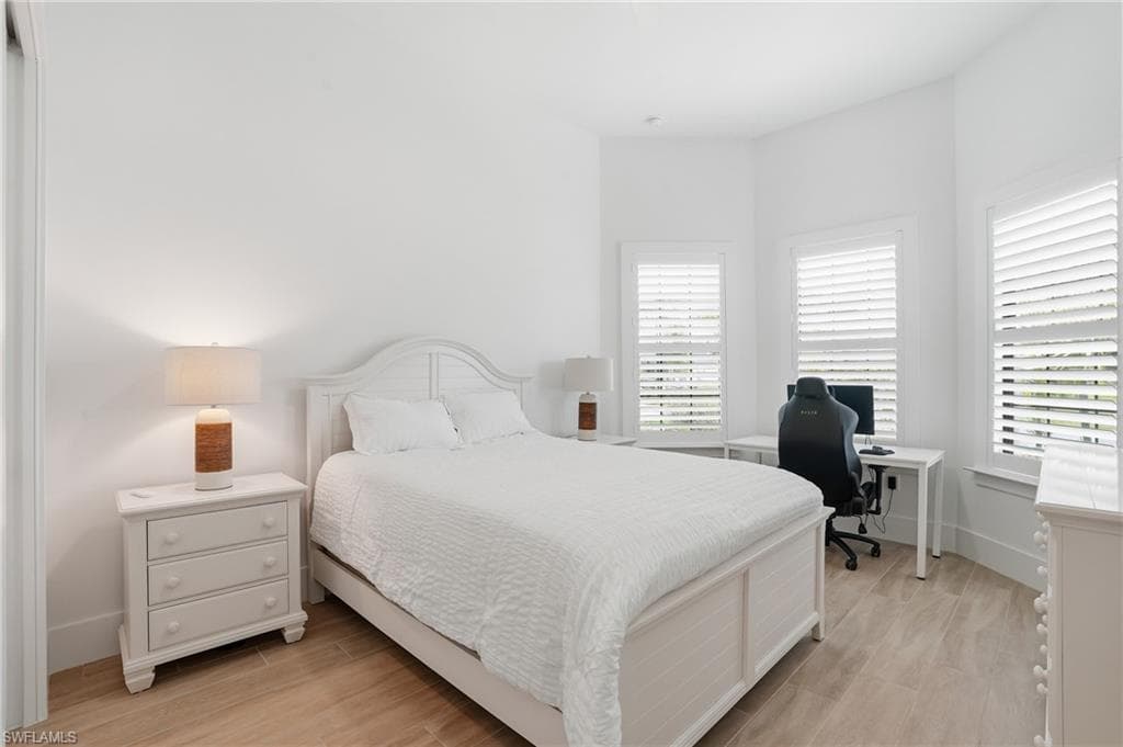 Bedroom featuring light wood-finish flooring and white walls
