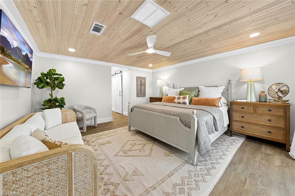 Wood-finish flooring and a wood-plank ceiling with recessed lighting
