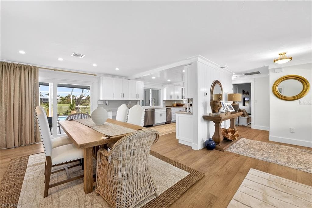 Open-concept interior featuring wood-finish flooring, recessed lighting, and white baseboards