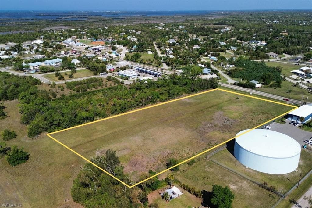 Expansive cleared land parcel outlined in yellow