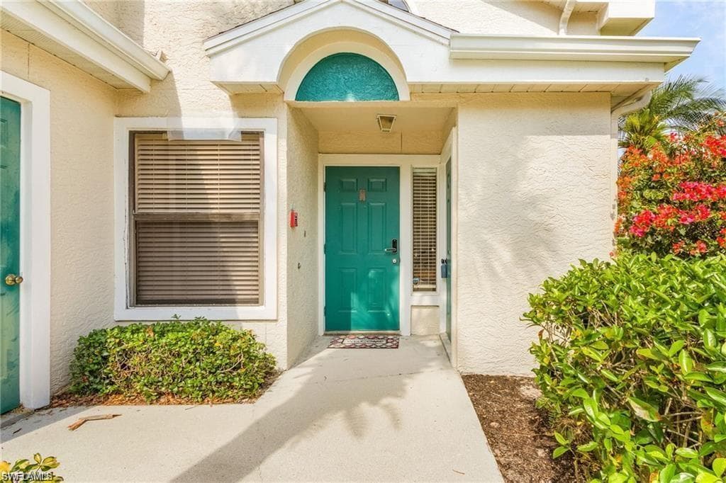Entrance to property featuring stucco siding
