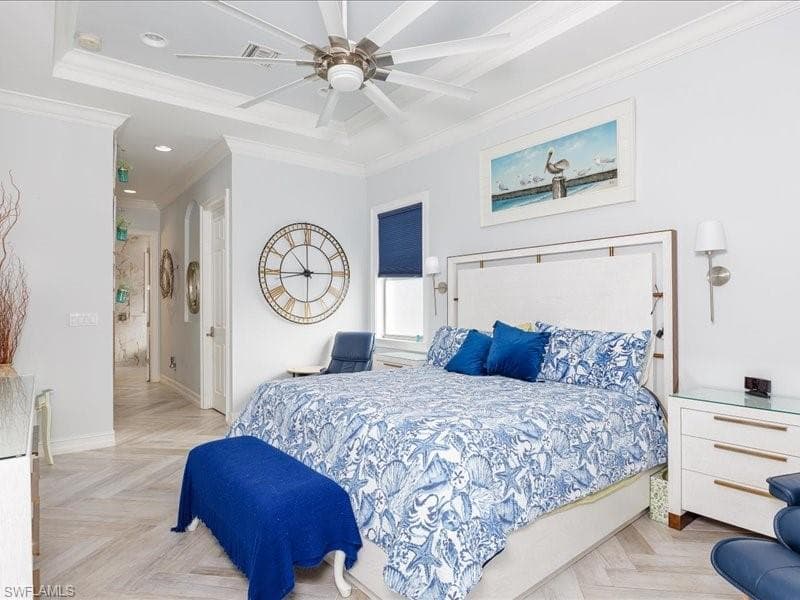 Recessed lighting and a ceiling fan illuminate this space, featuring wood-finish flooring in a herringbone pattern