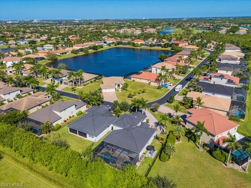 Aerial perspective showcasing a residential community with numerous properties featuring varied architectural styles and roofing materials