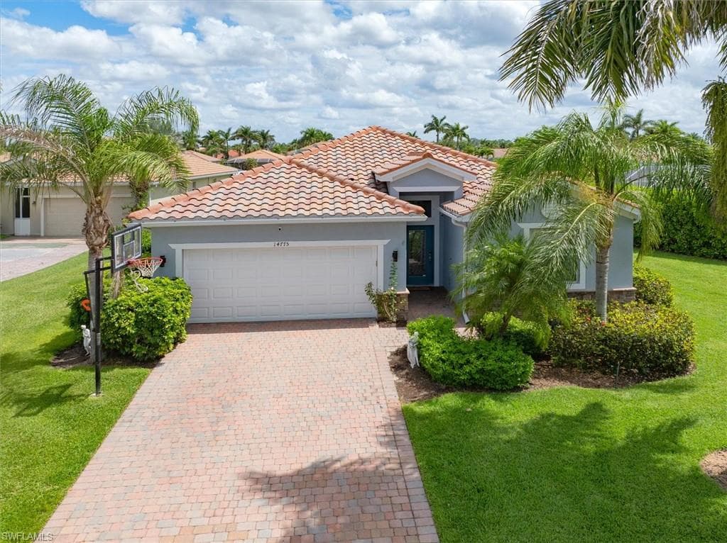 Freshly painted exterior with tile roof, brick paver driveway, mature landscaping, and excellent curb appeal on an extra wide cul-de-sac lot.