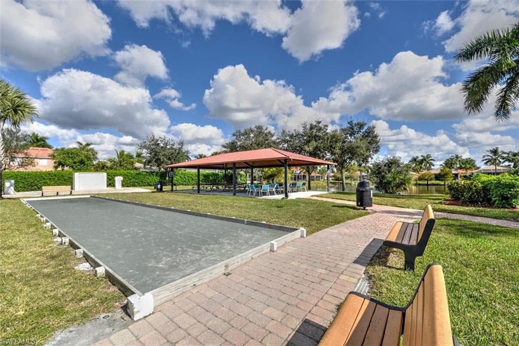 Community bocce court with paver pathway and benches for seating.