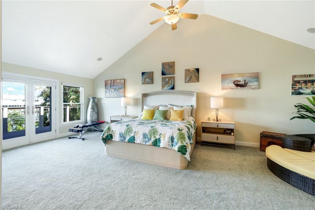 Large Primary Bedroom with French doors to a balcony overlooking the waterway,