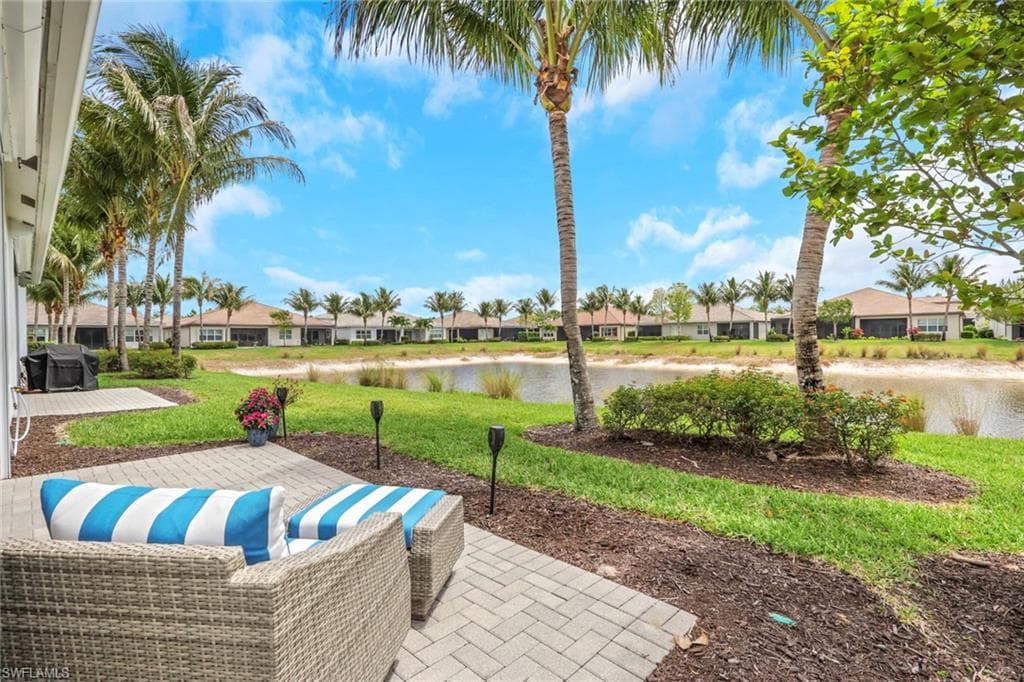 Expansive paver patio offering serene lake frontage