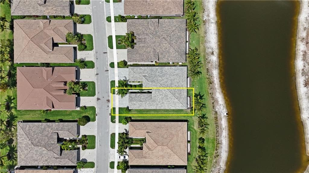 Aerial perspective of a single-family home with a gray tile roof and a concrete driveway