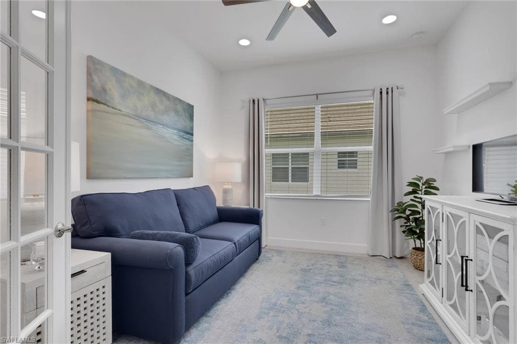 French doors open to a versatile room featuring recessed lighting, a ceiling fan, a large window with blinds, and light-colored carpeting