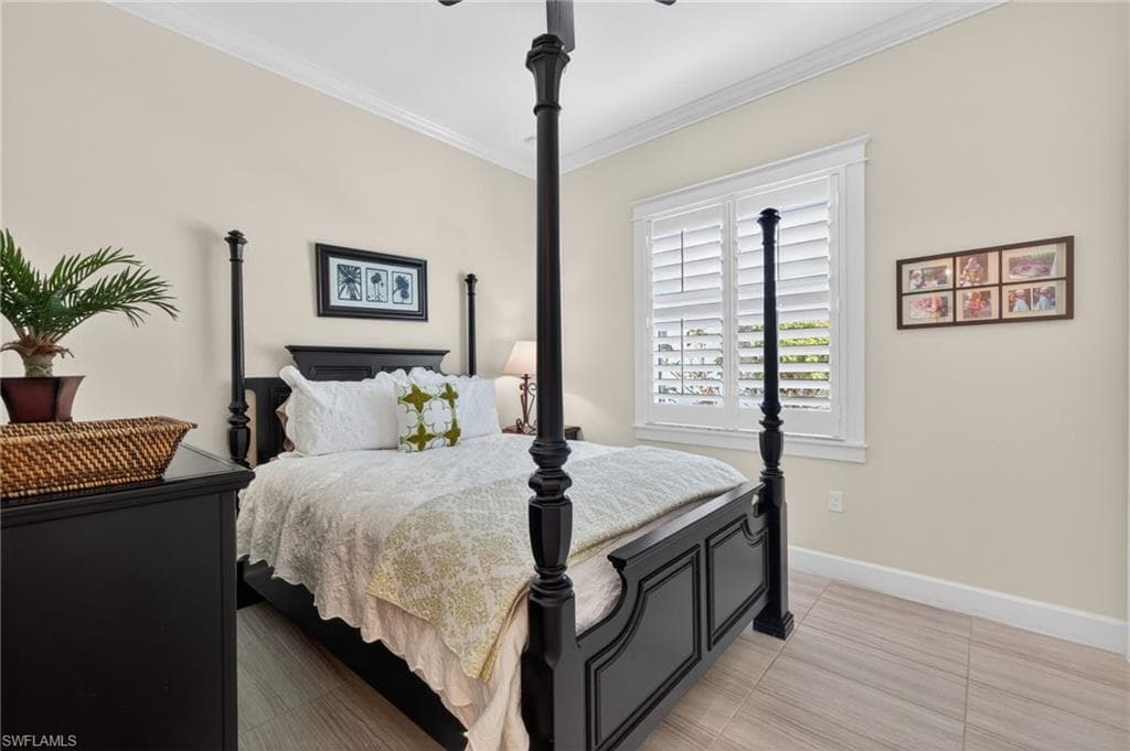 2nd bedroom features a walk-in closet, plantation shutter and plank tile flooring.