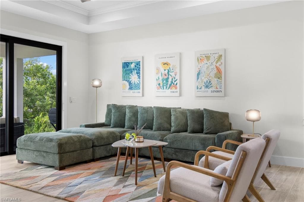 Living area with light wood-finish flooring and white walls