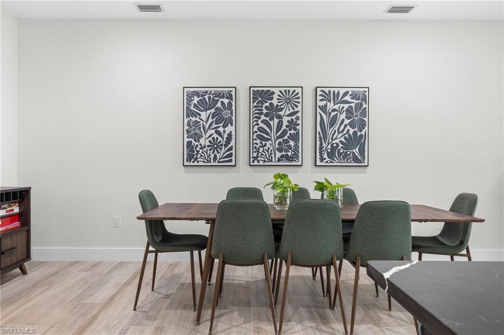 Bright interior space featuring light-toned walls, recessed lighting, and wood-finish flooring