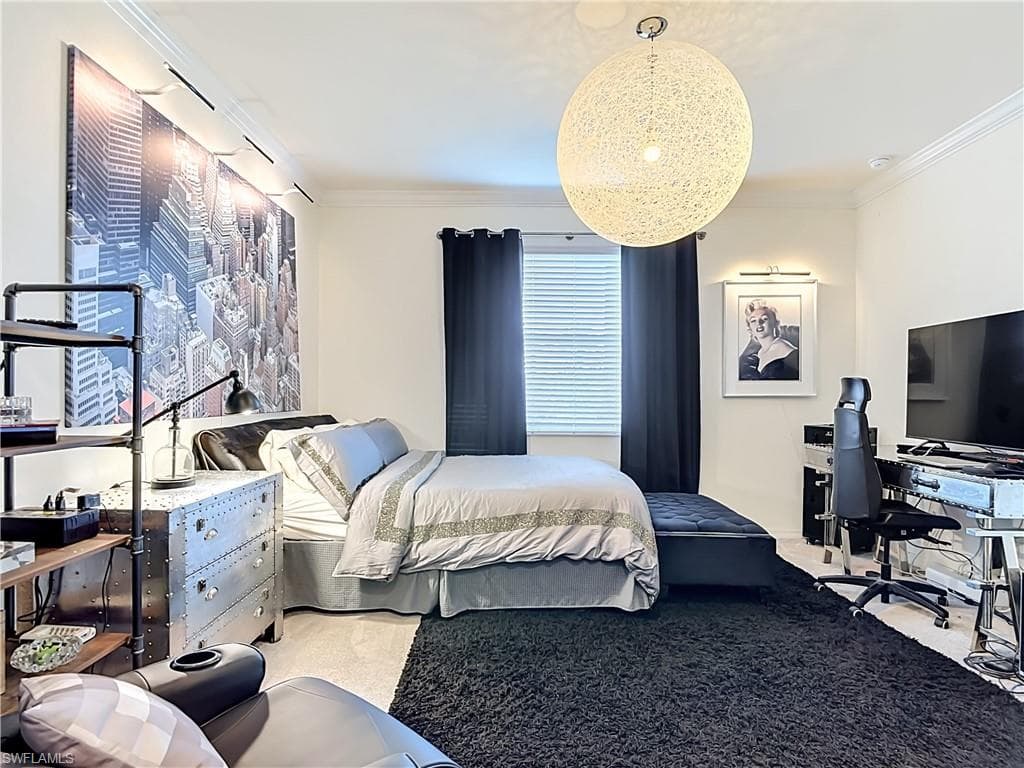 Spacious Primary Bedroom featuring light-colored walls and crown molding