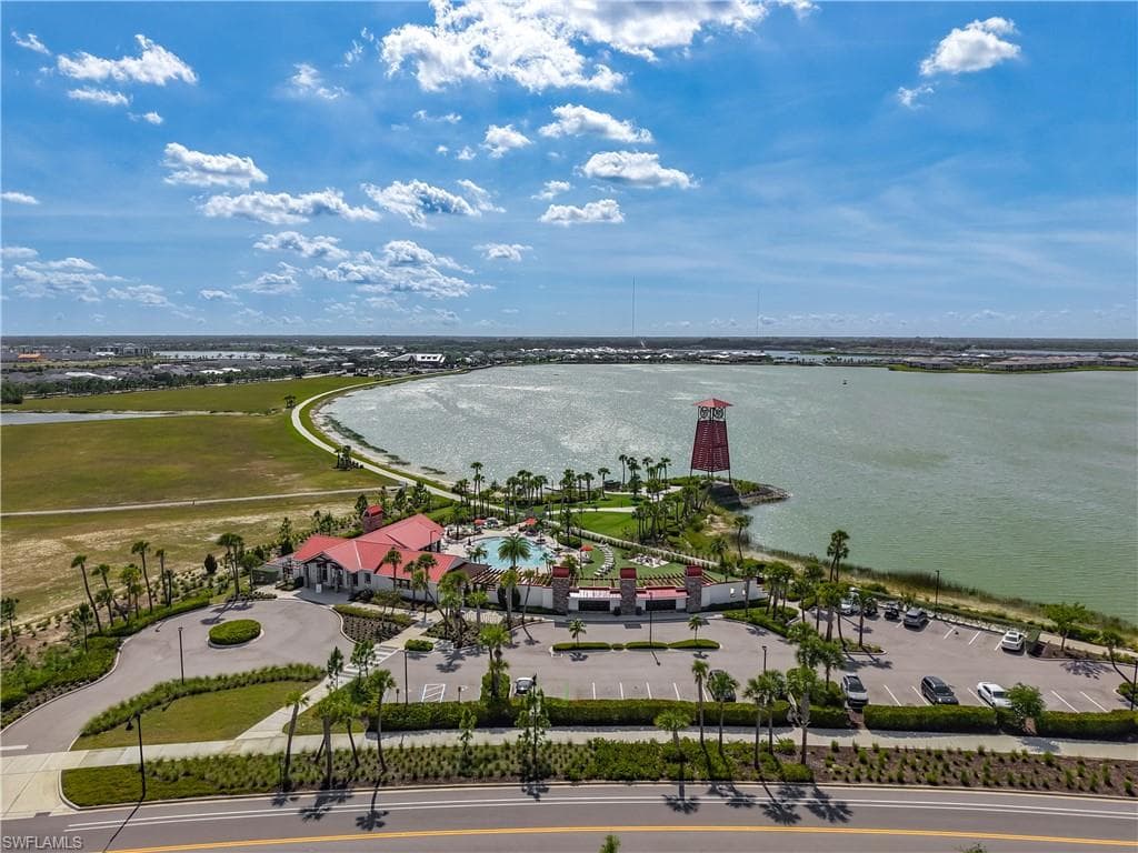 Community amenities featuring a resort-style pool, expansive deck, and a distinctive red lighthouse structure