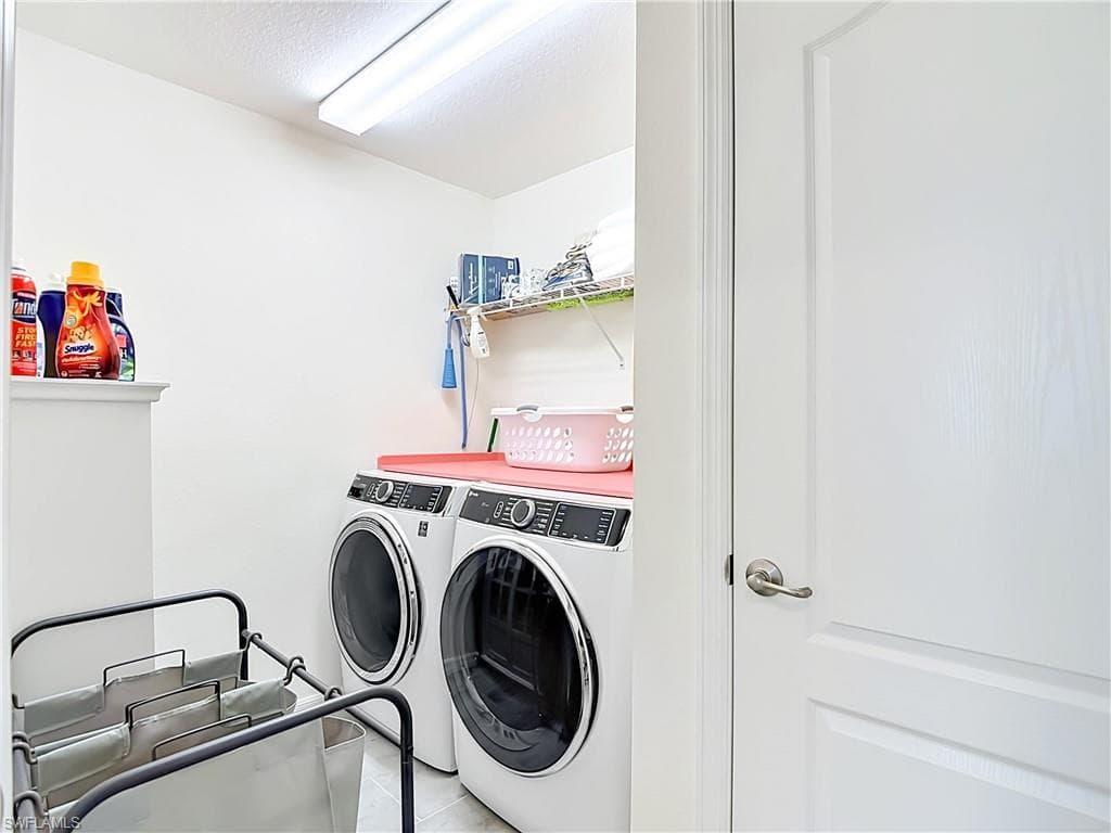 Utility room featuring two front-loading laundry machines located on the 2nd floor