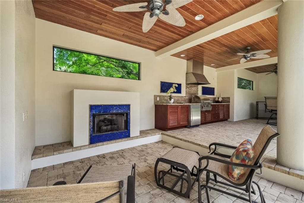 Fireplace Outdoors w/ Wood-Paneled Ceiling