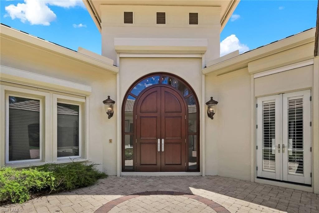 Custom Mahogany Doors off the Entry Courtyard Set a Tone of Luxury