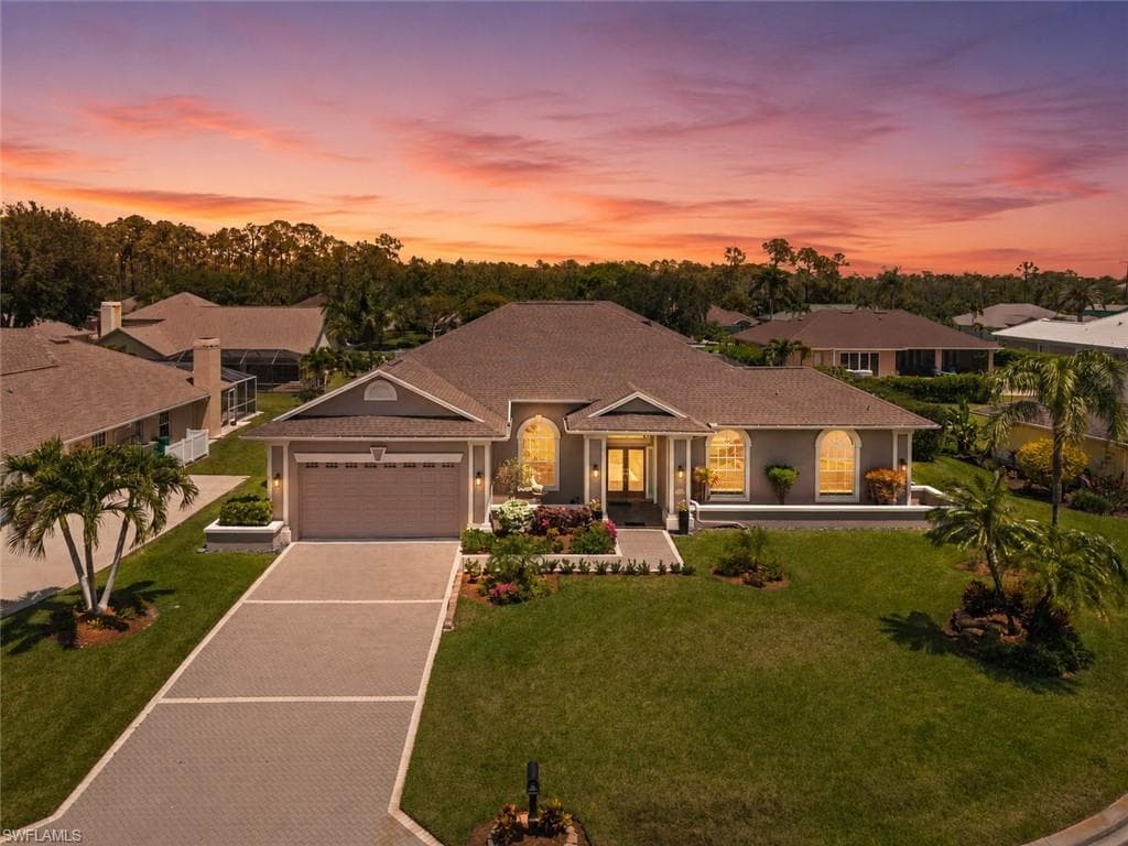 Expansive screened lanai featuring a paver patio, a rectangular swimming pool, multiple ceiling fans, and structural columns