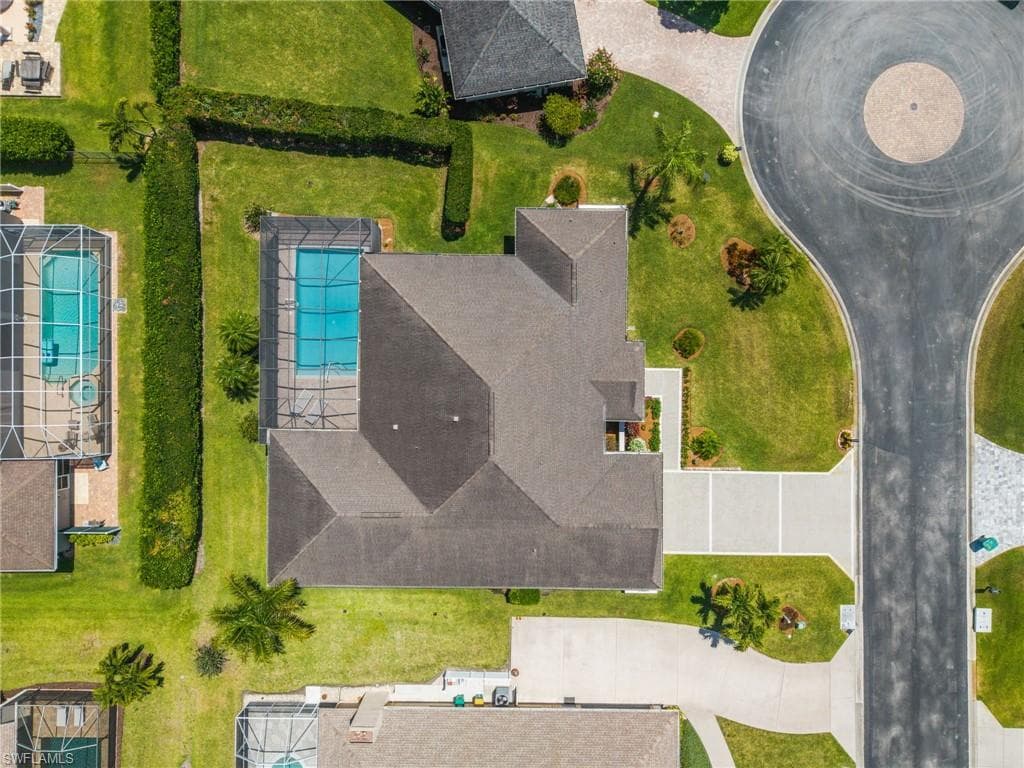 Property featuring a screened-in swimming pool, a concrete driveway, and a cul-de-sac