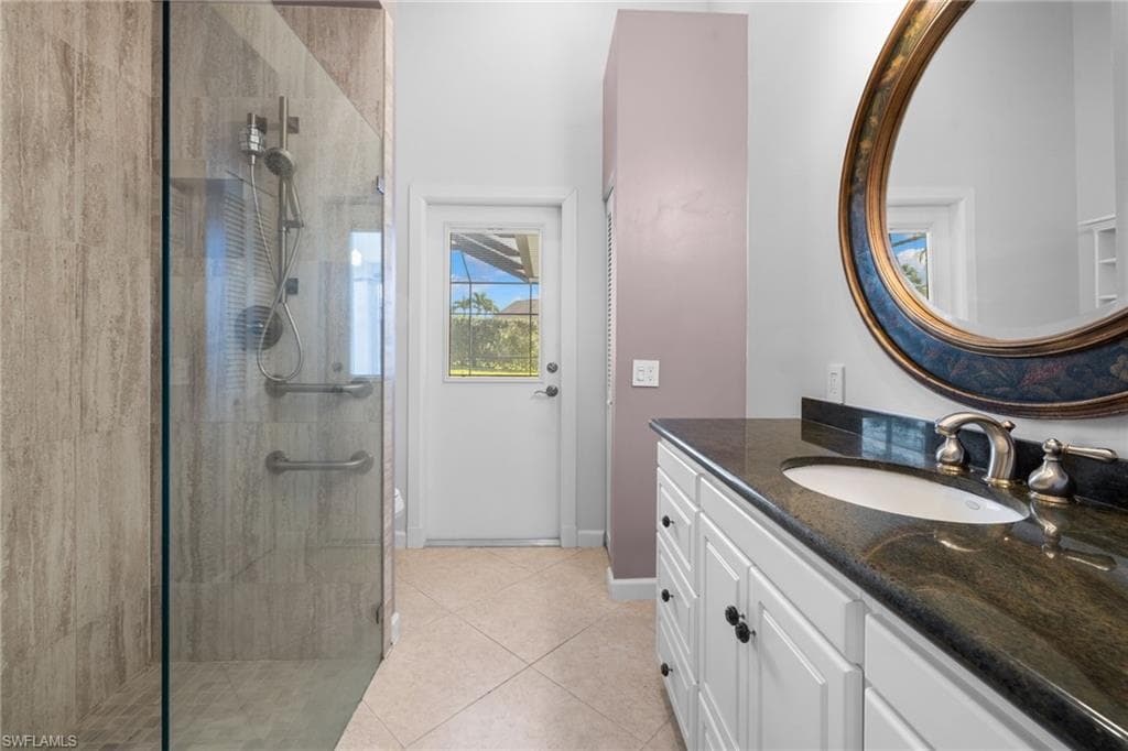 Bedroom #3, featuring bright interior, french doors to outdoor living space, spacious closet, wood-finish flooring, and a ceiling fan